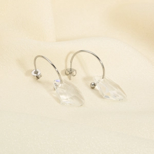 Macro shot of silver stainless steel hooks with transparent crystal drop earrings