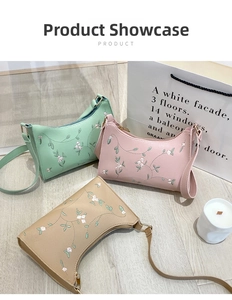 Close-up of three baguette underarm bags in mint, pink, and khaki with floral embroidery