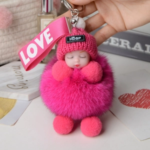 Detail of rose red fox fur pompom keychain with sleeping baby doll and love strap