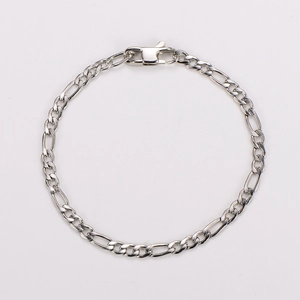 Detailed view of silver Figaro chain bracelet with lobster clasp on white background