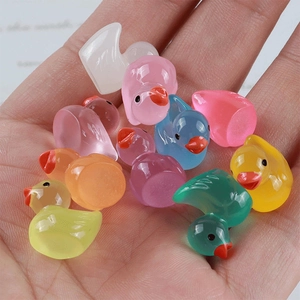 Mini resin ducks in hand showing compact size for DIY crafts and micro-landscape decor