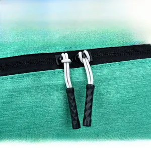 Detail view of durable two-way zipper and green textured fabric on lightweight backpack
