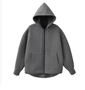 Detailed view of the dark grey hooded jacket with front pockets and sturdy metal zipper
