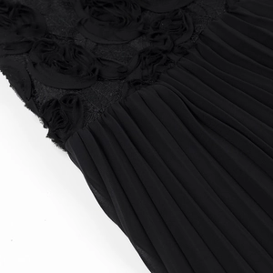 Macro detail of black lace dress featuring 3D floral rosettes and pleated chiffon texture