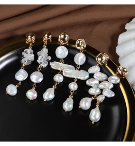 Detailed close-up of French baroque freshwater pearl earrings with gold-plated finish
