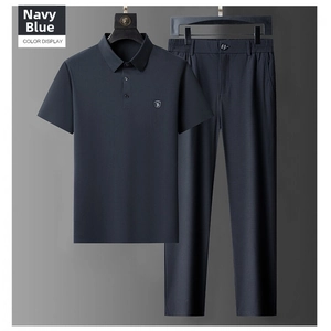 Detail view of navy blue ice silk polo shirt and matching trousers set on a hanger