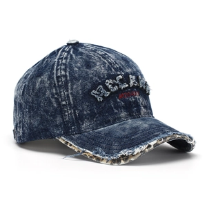 Detail of washed denim baseball cap with distressed brim and leopard print lining