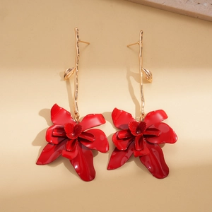 Retro red flower drop earrings with golden branch design on beige textured background