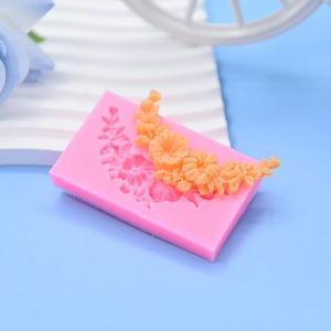 Pink silicone floral mold with orange curved bouquet flower designs for cake and crafts
