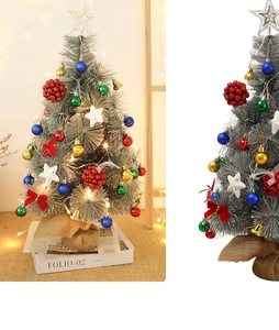 Detail of a 60cm mini silver Christmas tree with LED lights and festive ornaments
