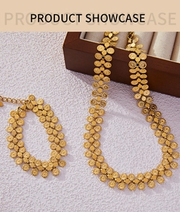 Detailed macro of golden floral necklace and bracelet set with hollow relief texture