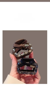 Detail of vintage ribbon hair claws with sparkling rhinestones and Lovedays logo