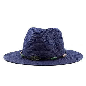 Detail of navy straw fedora hat featuring colorful beads and antique bronze buckle