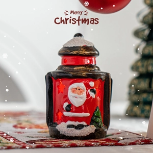 Festive Santa Claus lantern decoration with warm light and snowy details for Christmas