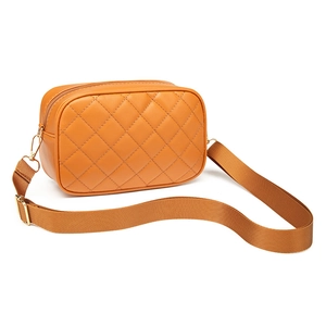 Orange quilted crossbody camera bag for women with adjustable strap and metal hardware