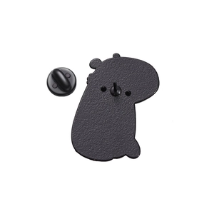 Close-up of matte black metal back of capybara enamel pin with rubber clutch