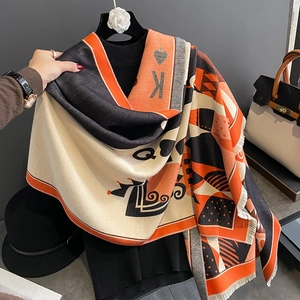 Scarf with poker K and Q patterns in orange and black knit blend with fringe