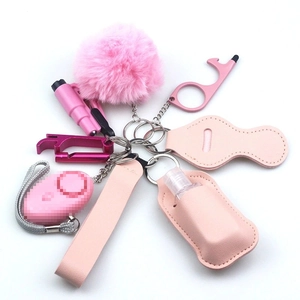 Detailed pink neoprene keychain set with fluffy pom pom, bottle holder and security tools