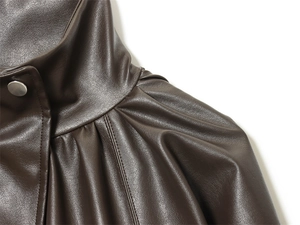 Close-up of a dark brown PU leather jacket featuring a stand collar and silver metal snaps