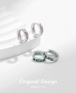 Detailed close-up of S925 sterling silver hoop earrings with pink and green heart gems