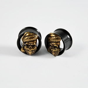 Detail of black double flared ear plugs featuring gold skull with Christmas hat designs