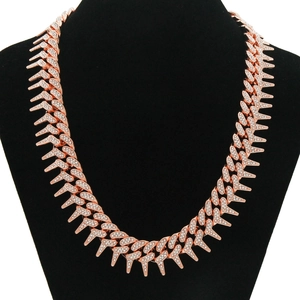 Detailed close-up of rose gold iced-out spiked Cuban link chain with white crystals