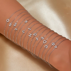 925 sterling silver alphabet bracelet with zircon charms on elegant silk background