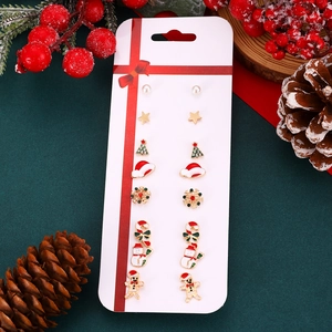 Flat lay of Christmas stud earring set with Santa, tree, and snowflake patterns