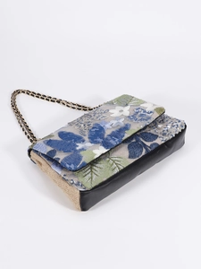 Detail of floral embroidery and sequins on canvas shoulder bag with black PU leather base