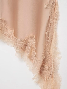 Close-up of champagne silk fabric with exquisite eyelash lace trim detail