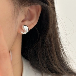 Close-up of minimalist S925 sterling silver water drop stud earring on female ear