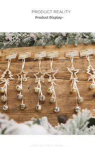 Detail of glittery Christmas ornaments with bells and snow-covered pine branches