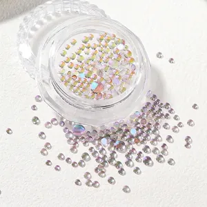 Macro shot of mixed size mermaid aurora glass beads for nail art in round plastic container