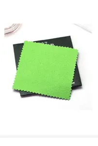 Detail of light green microfiber jewelry cleaning cloth with serrated edges on black box