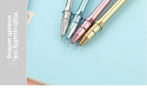Close-up of metallic shuttlecock pens in silver, blue, pink, and gold on a notebook