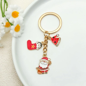 Christmas keychain with gold ring featuring enamel Santa, stocking and rhinestone hat