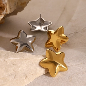 Polished gold and silver star earrings on natural rock showing 3D mirror finish