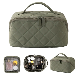 Detail view of large olive green quilted makeup bag with internal dividers and zip pouch