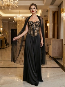 Close-up of black lace corset bodice and mesh shawl of elegant evening gown