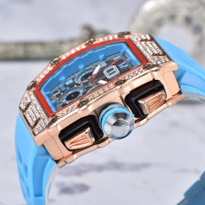 Detail of rose gold tonneau watch with blue dial and diamond-encrusted bezel