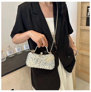 Detailed close-up of sparkling silver sequin evening bag with elegant pleated texture