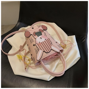 Close-up of pink leather bucket bag with 3D cartoon rabbit and embossed bear patterns
