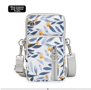 Close-up of Oxford fabric crossbody phone bag with blue leaves and yellow fruit pattern
