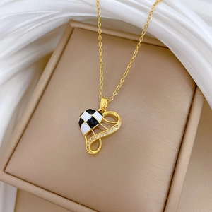Golden titanium steel heart necklace with houndstooth enamel and sparkling zircons