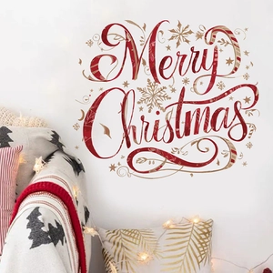 Detail showing red and gold Merry Christmas lettering wall stickers in a cozy bedroom