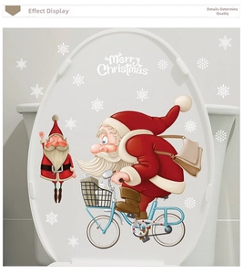 Détail de l'autocollant Père Noël à vélo pour abattant WC avec texte de Noël