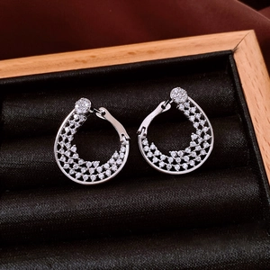 Macro shot of silver crystal-encrusted geometric earrings in a black velvet jewelry box