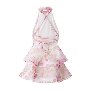 White floral halter neck mini dress with backless crisscross straps and ruffled hem