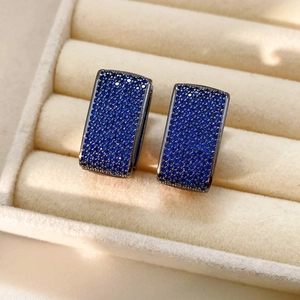 Macro detail of vintage rectangle earrings with deep blue pavé set zircon crystals
