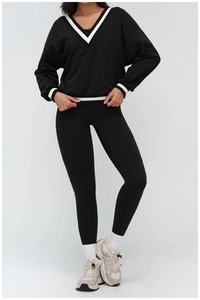 Detail of V-neck sweatshirt with striped collar and cuffs on black sporty activewear
